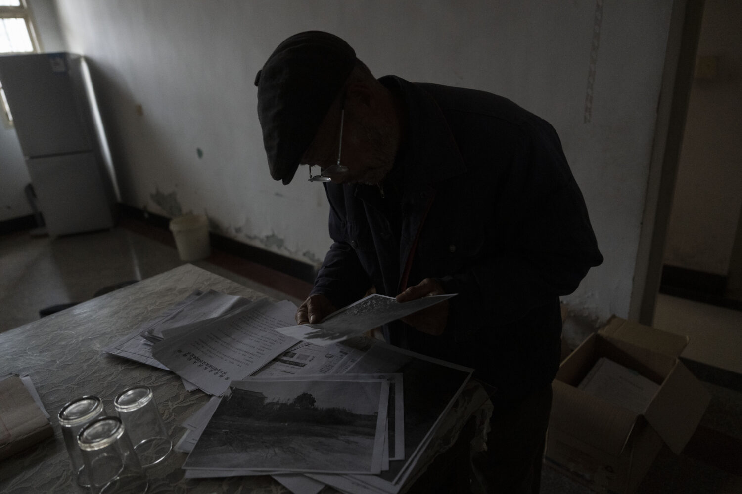 Petitioner Yang Guoliang looks through documents at his home in Changzhou in eastern China's Jiangs...