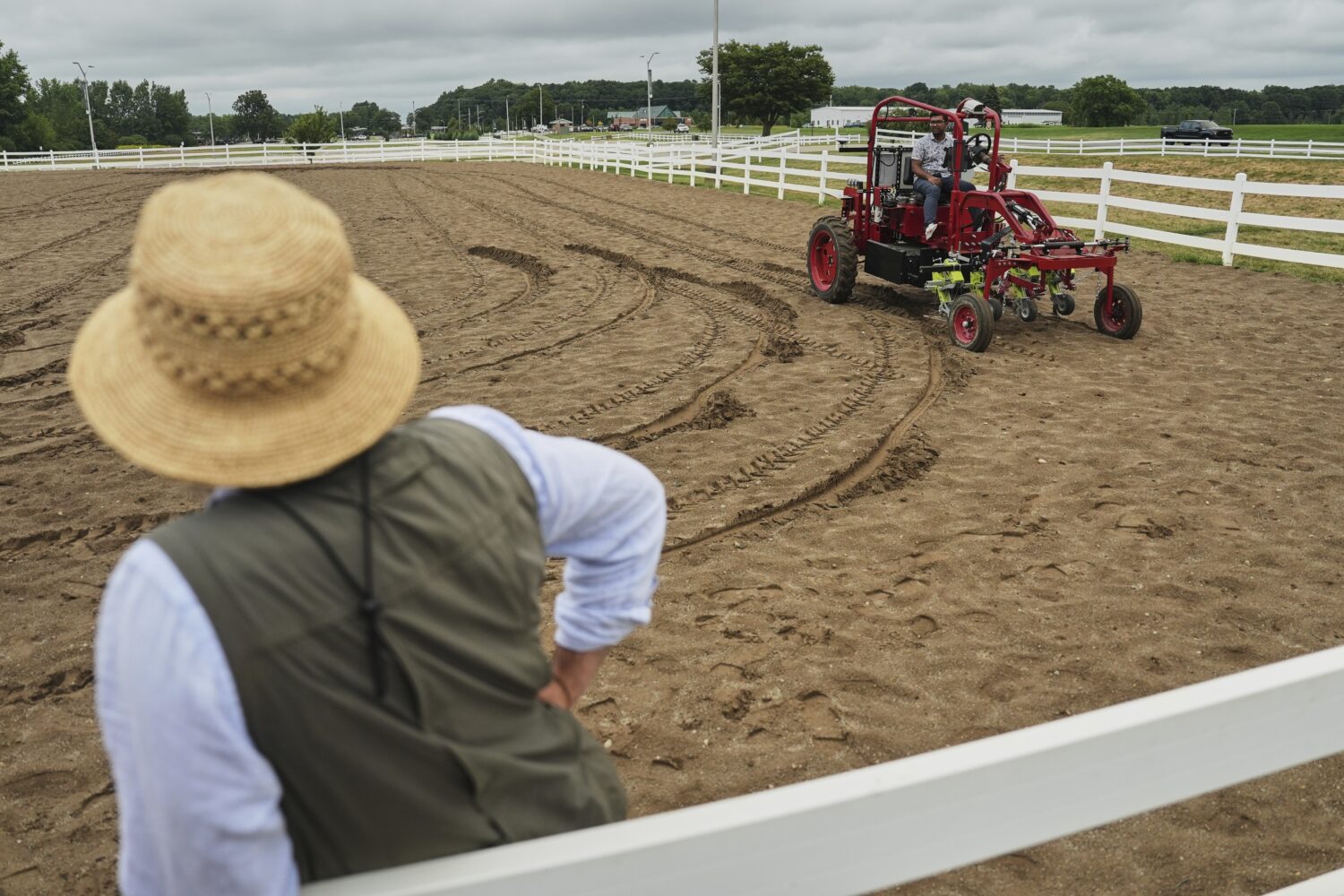 MK Bashar, right, test drives an electric tractor as Ben Phillips, left, watches Tuesday, Aug. 19, ...