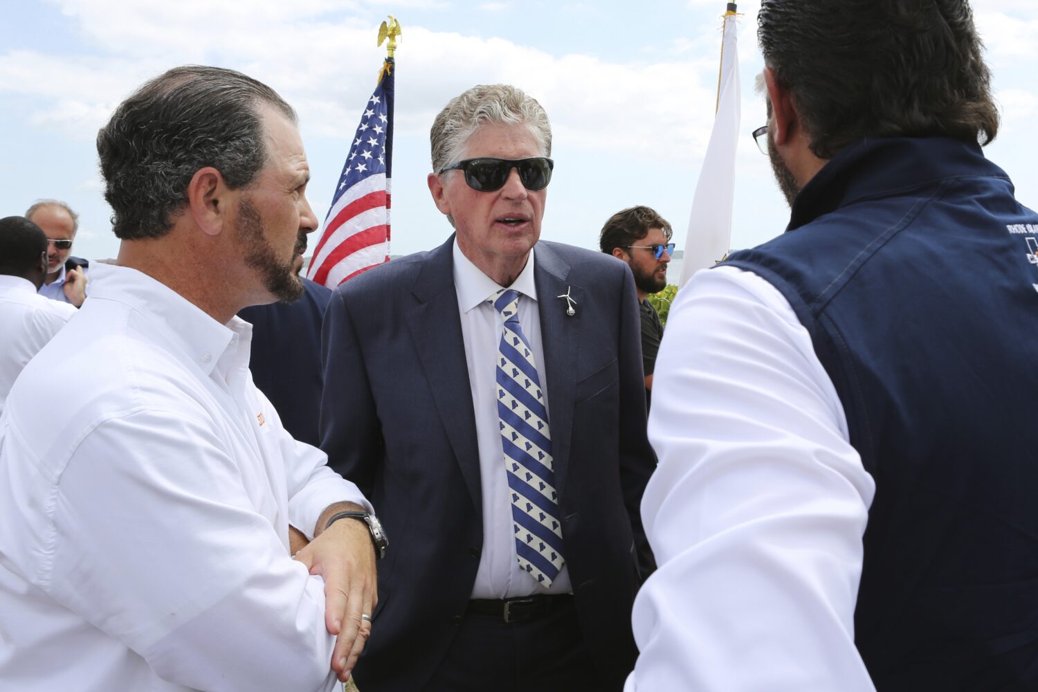 Rhode Island Gov. Dan McKee, center, speaks with Laborers' International Union of North America lea...