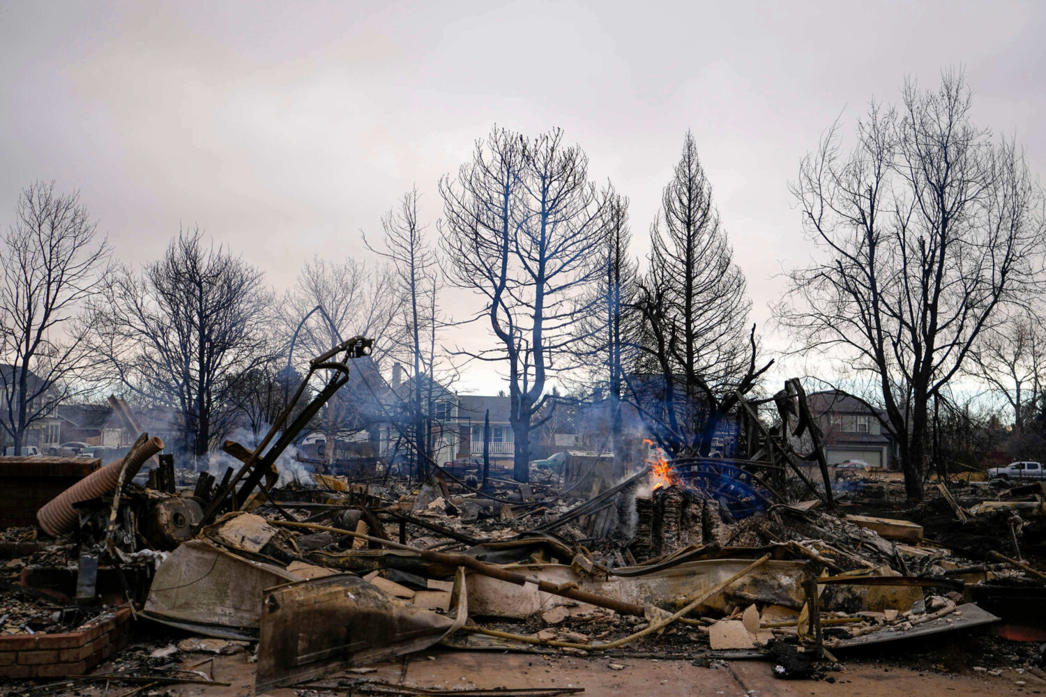 FILE - A fire burns in a home destroyed by the Marshall Wildfire in Louisville, Colo., Dec. 31, 202...