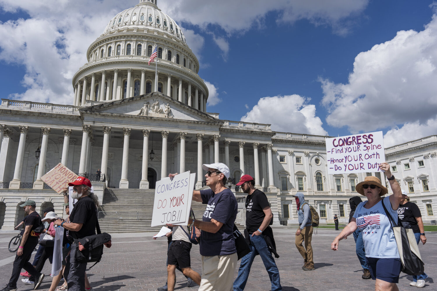 Demonstrators protest the policies of President Donald Trump, the Congress, and the delay in the Ep...