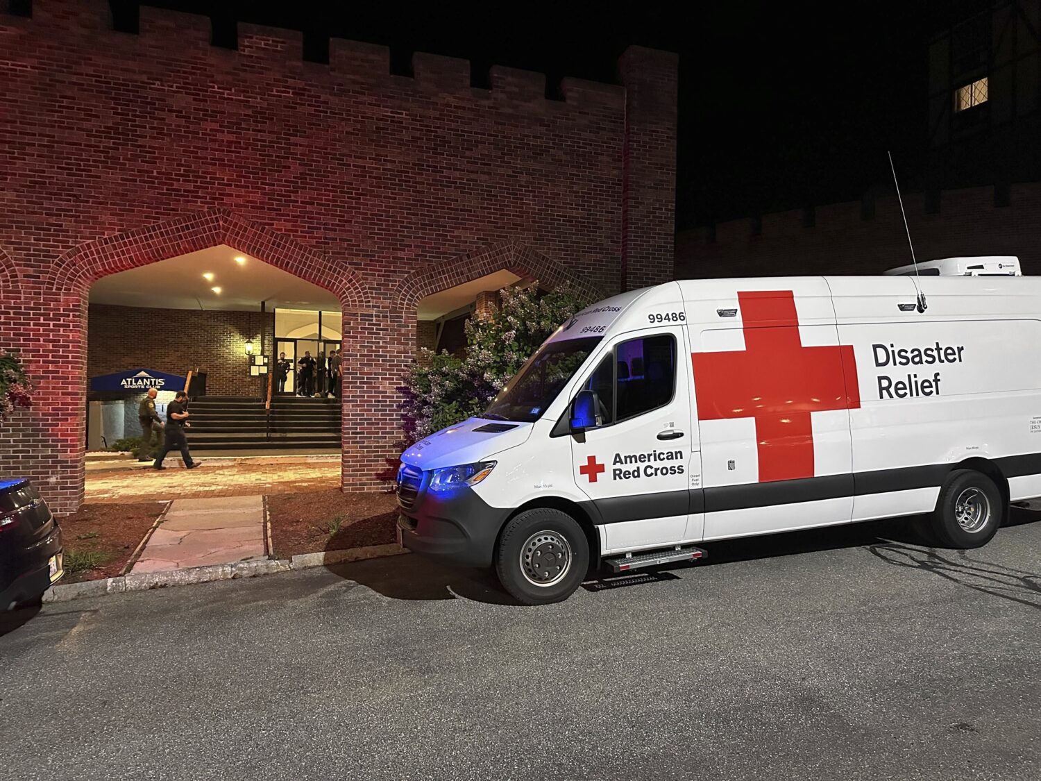 An American Red Cross Disaster Relief van is parked outside a hotel that is acting as a reunificati...