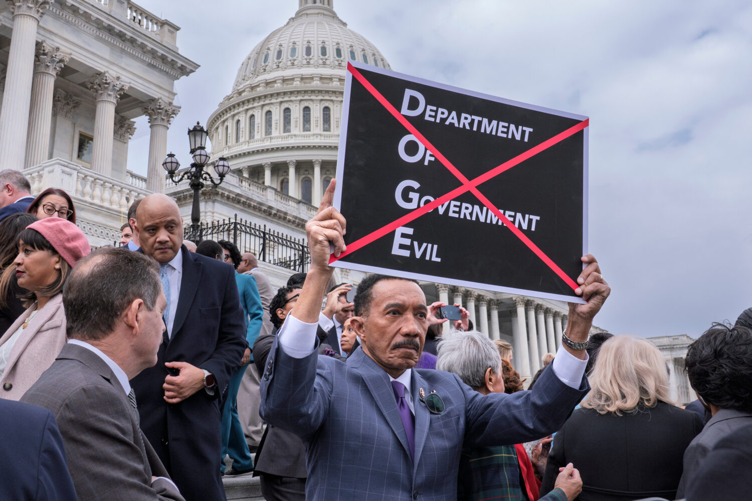 FILE - Rep. Kweisi Mfume, D-Md., protests against DOGE, the Department of Government Efficiency, as...
