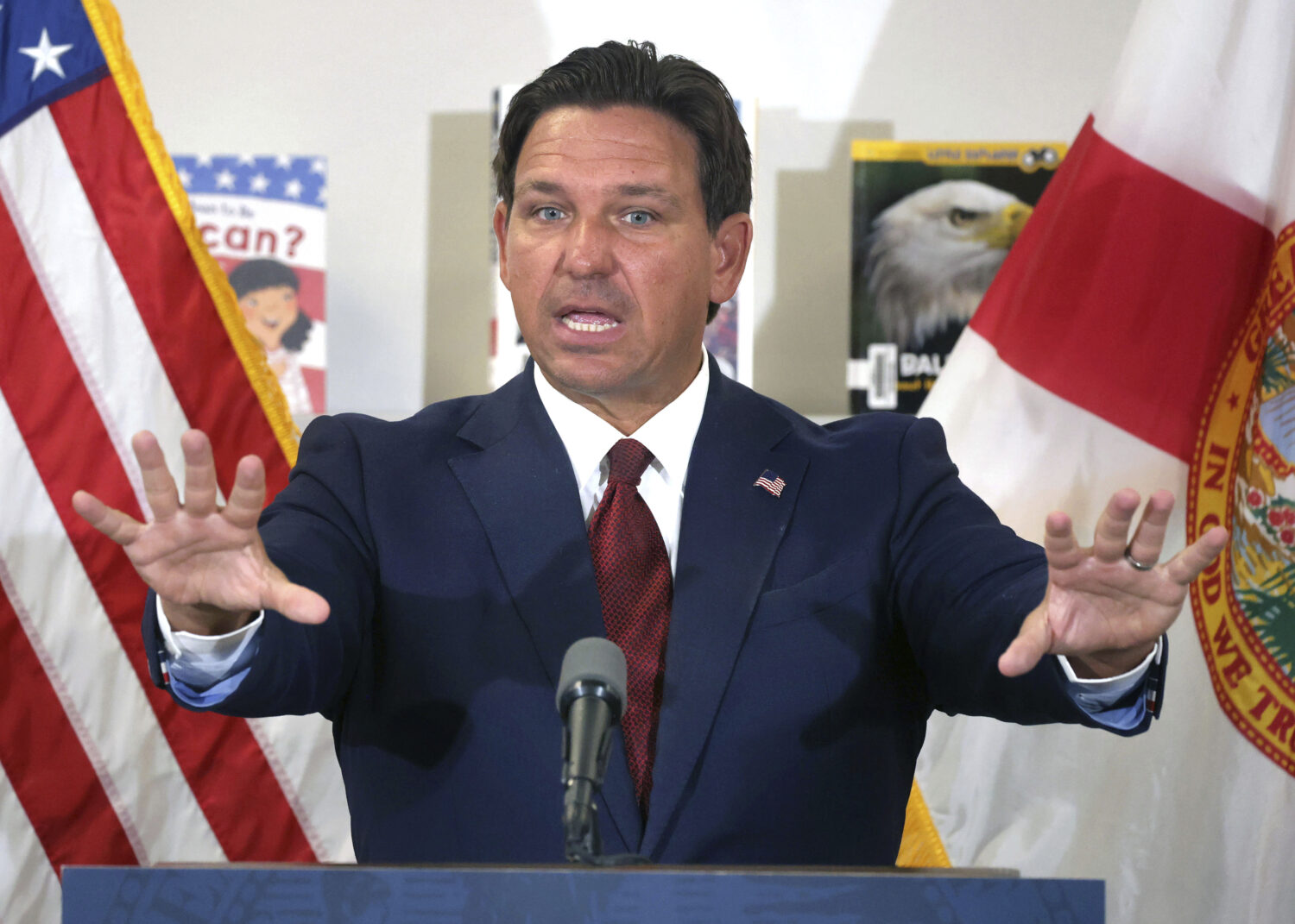 Florida Gov. Ron DeSantis answers a question after announcing a lawsuit against book publishers McG...