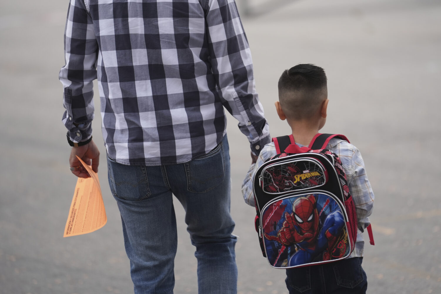 A parent and student arrive on the first day of school Thursday, Aug. 14, 2025, in Los Angeles. (AP...