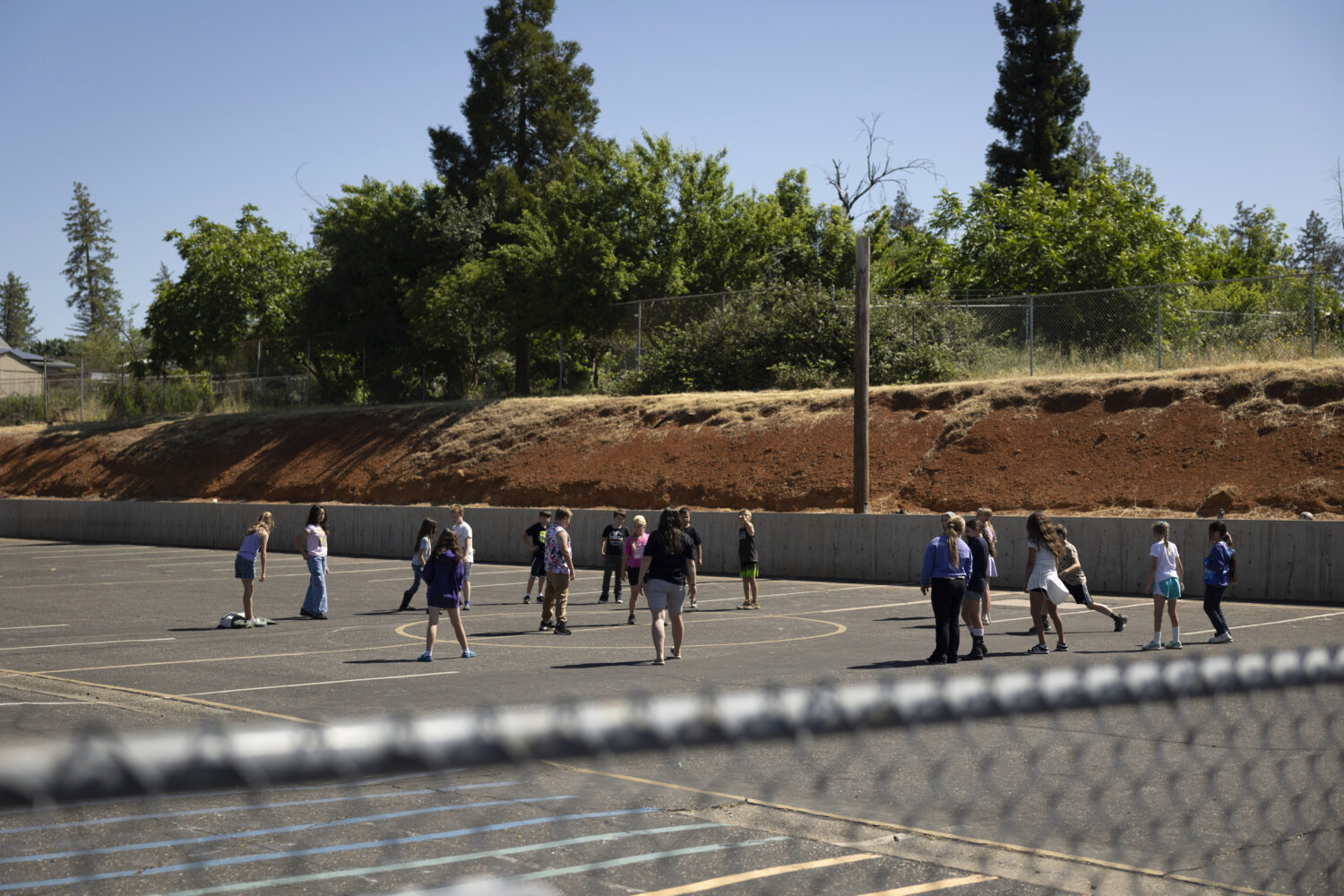 Students play on the playground at Achieve Academy School of Paradise in Paradise, Calif., May 21, ...
