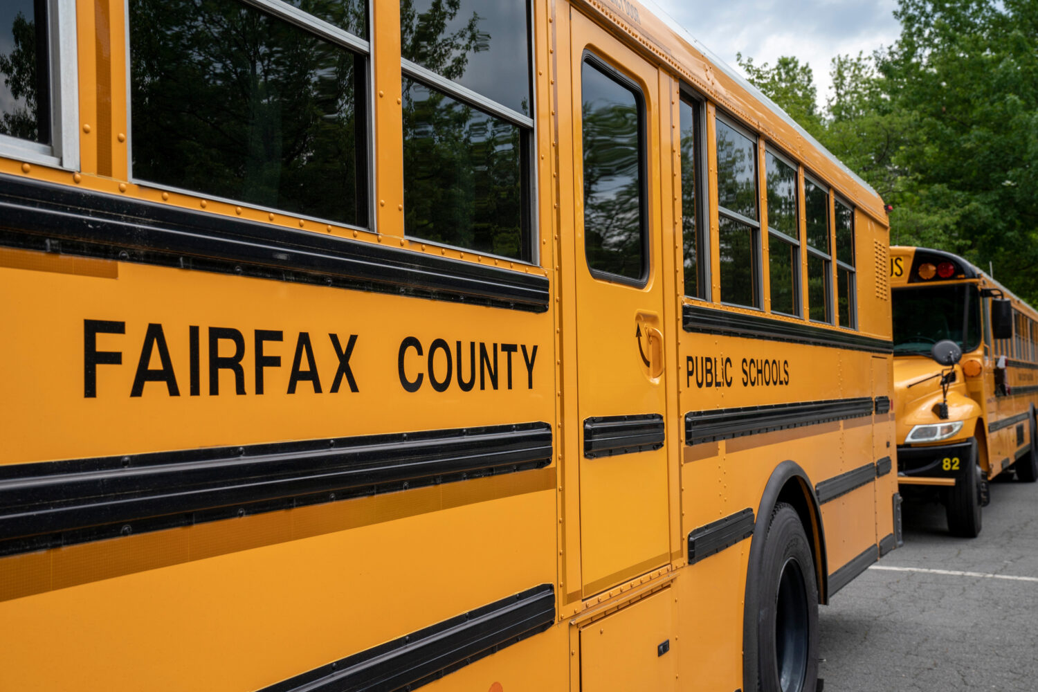 FILE - Fairfax County Public School buses idle at a middle school in Falls Church, Va., July 20, 20...