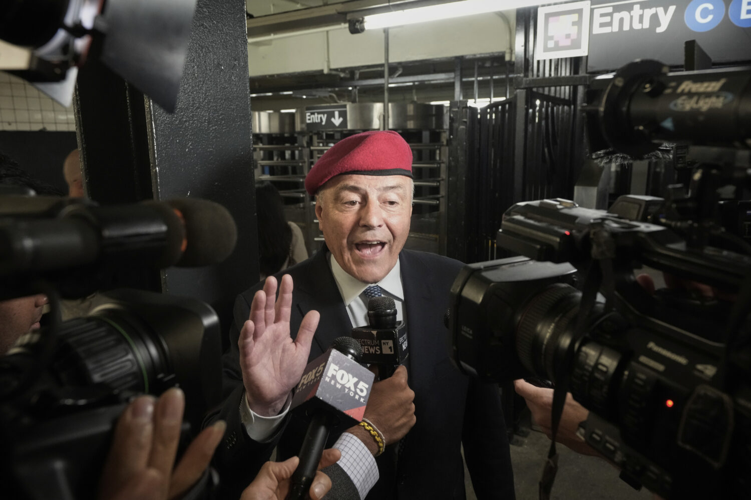 New York City mayoral candidate Curtis Sliwa is interviewed in a subway entrance as he campaigns, i...