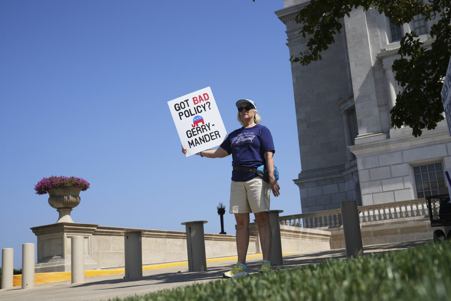 Robin Rothove holds a sign outside the Missouri Capitol as lawmakers prepare to hold a committee he...