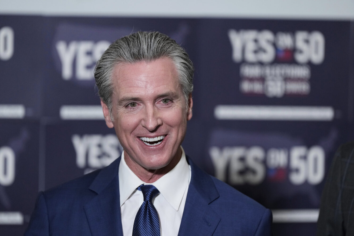 California Gov. Gavin Newsom answers questions after signing legislation calling for a special elec...