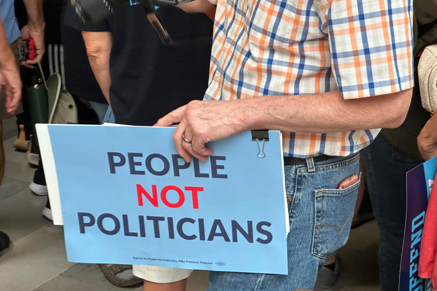 A protestor holds a sign in opposition to a plan redrawing Missouri's U.S. House districts during a...