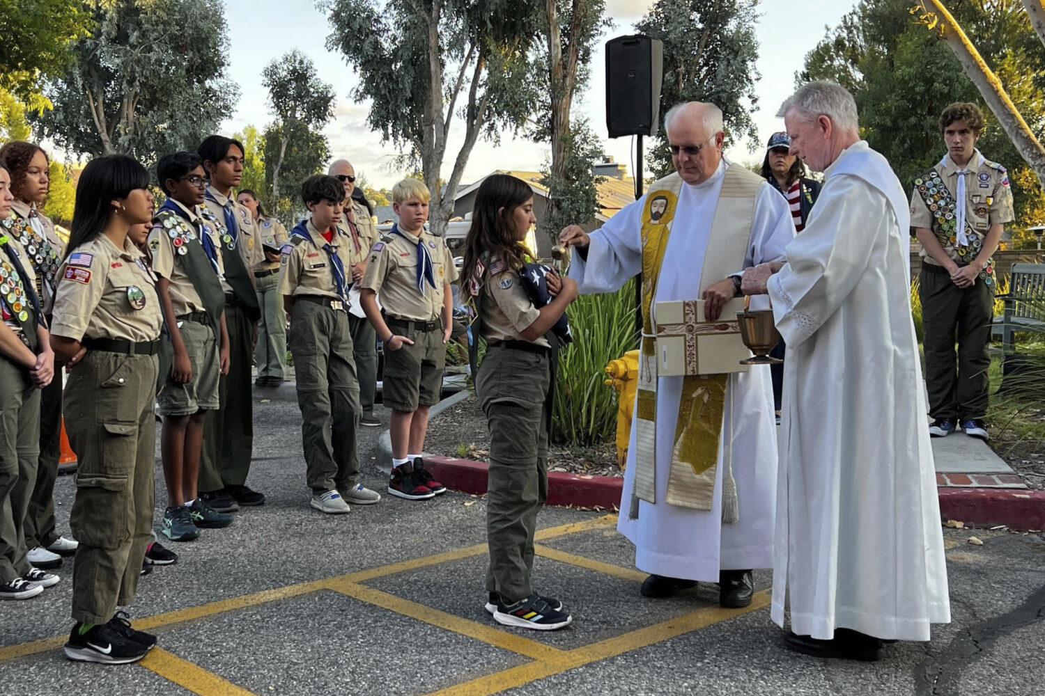Scout Troop 228 participates in the U.S. flag retirement ceremony for Saint Kateri Tekakwitha Churc...
