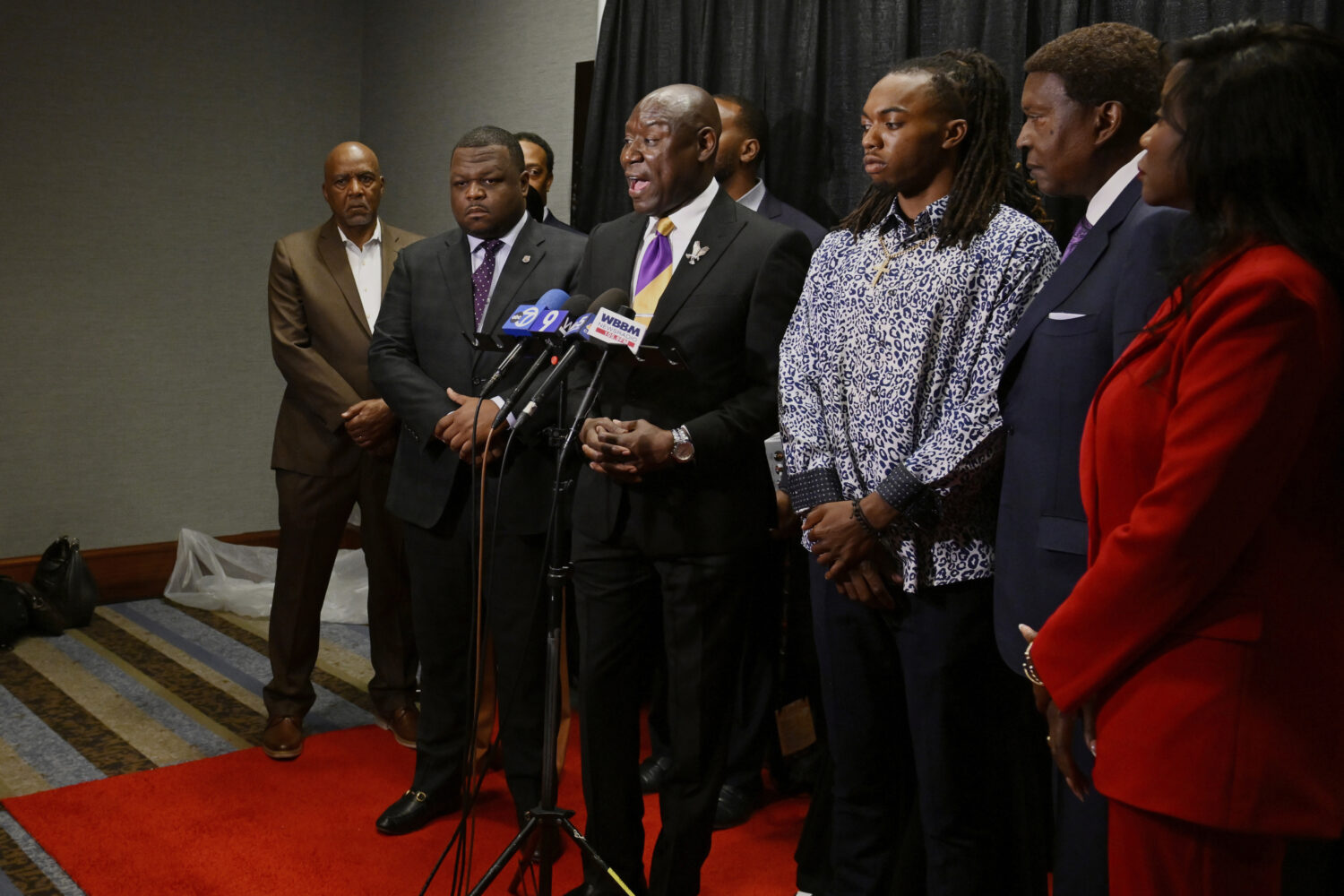 FILE - William McNeil Jr., third from right, looks on while his attorney Ben Crump, center, speaks ...