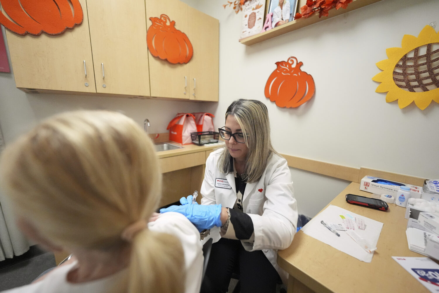 Pharmacy manager Aylen Amestoy administers a patient with a COVID-19 vaccine at a CVS Pharmacy in M...