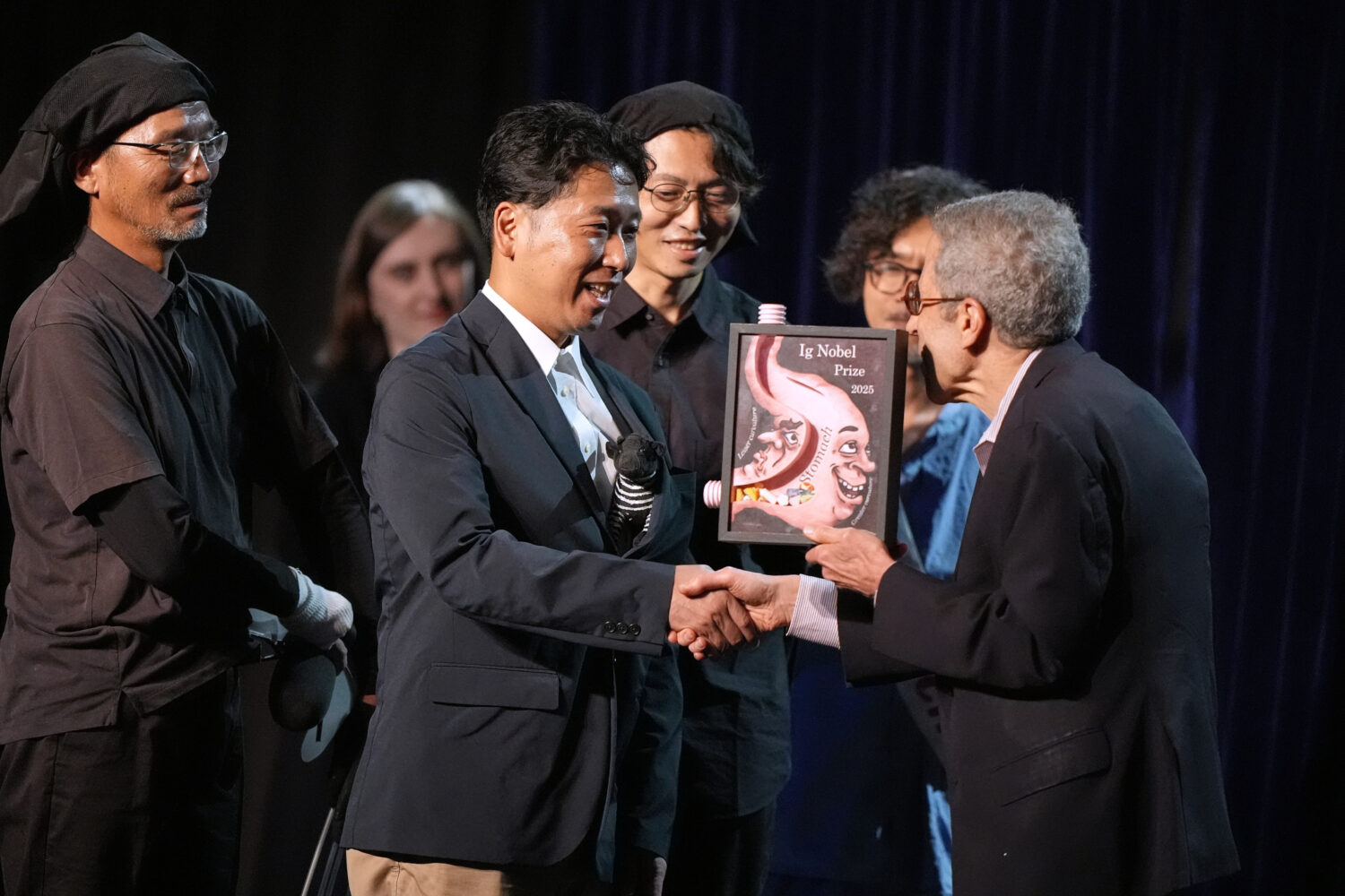 The Ig Nobel Prize for biology is accepted by Tomoki Kojima, Kazato Oishi, Yasushi Matsubara, Yuki ...