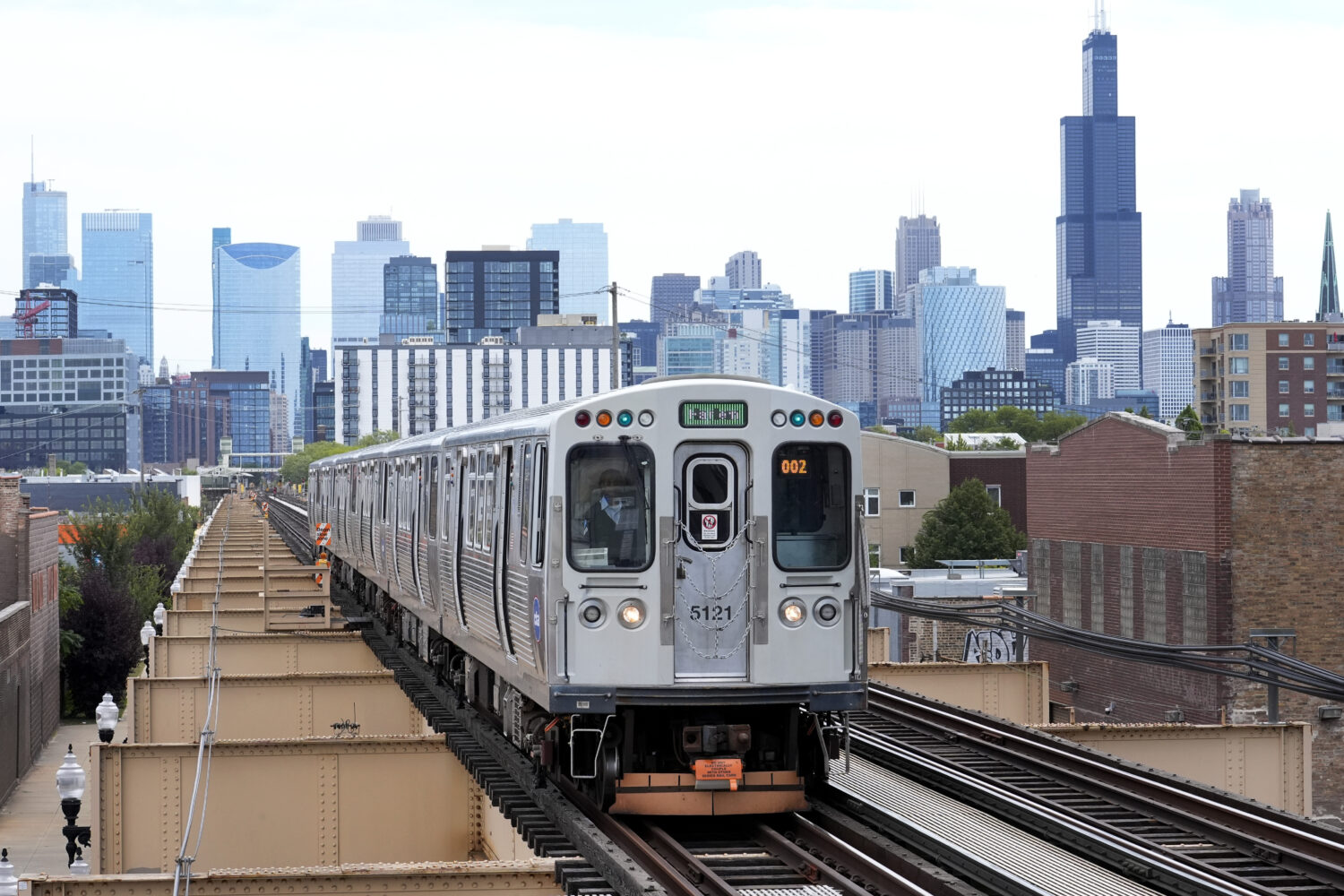 FILE - A Chicago Transit Authority train pulls into the Damen Ave. station on Aug. 12, 2024, in Chi...