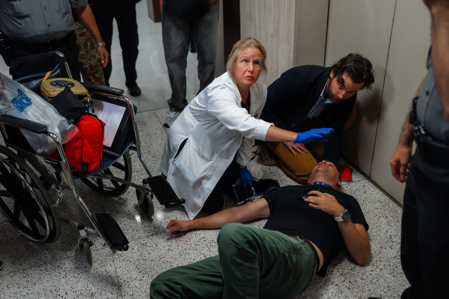Journalist L. Vural Elibol receives medical assistance after being shoved by federal agents in immi...
