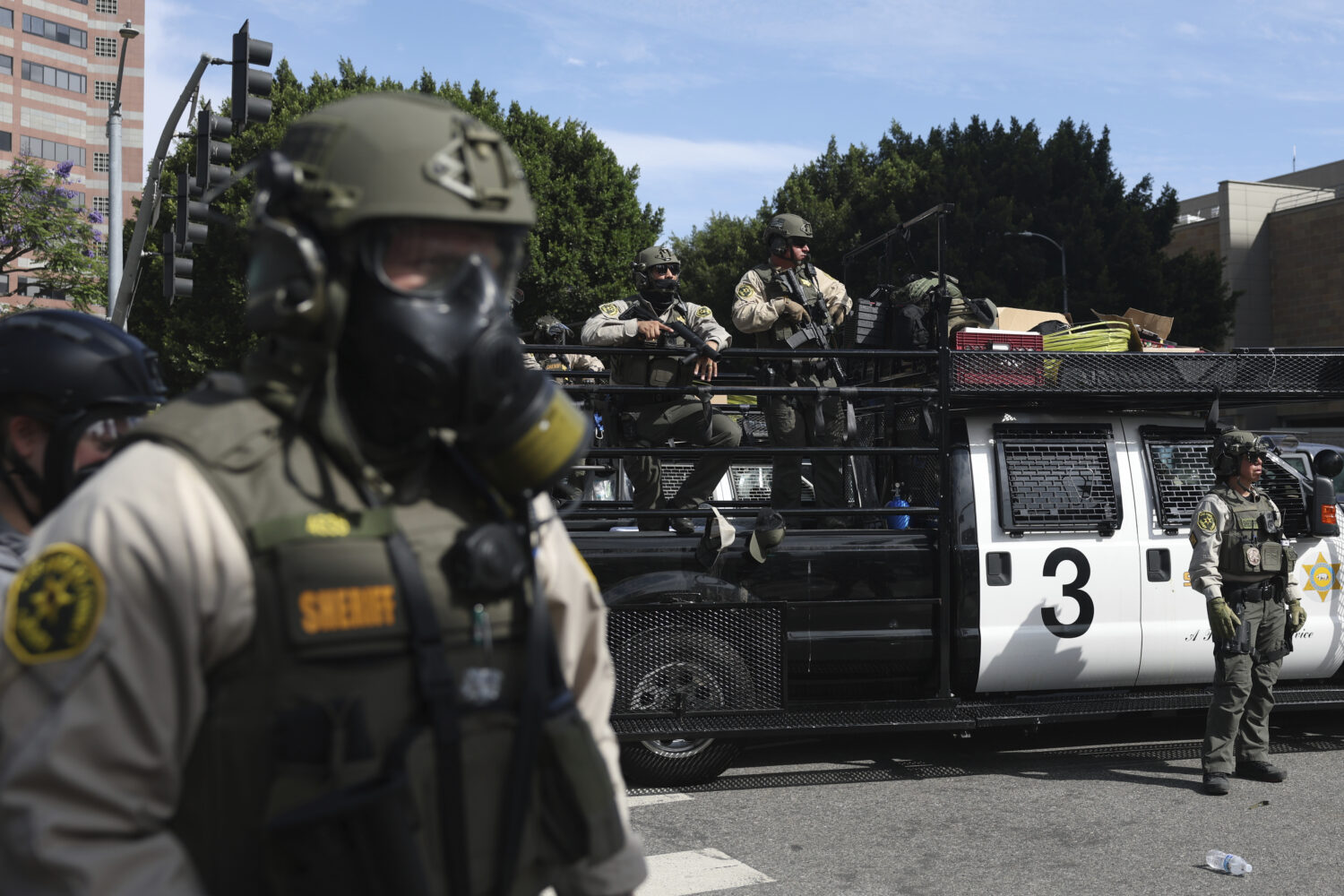 FILE - Law enforcement officers stand guard during a protest June 14, 2025, in Los Angeles. (AP Pho...