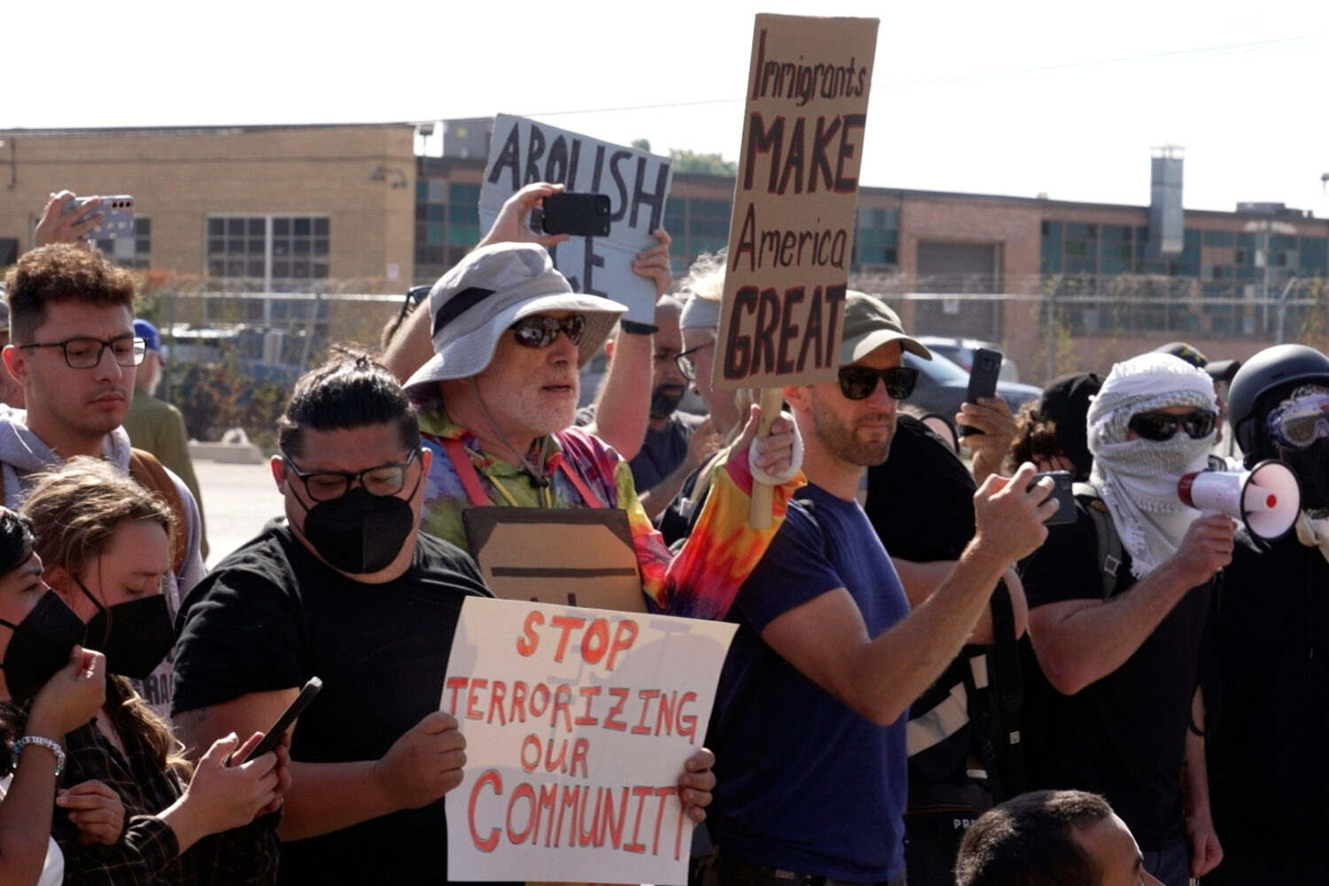 People protest outside of an immigration facility guarded by federal agents Friday, Sept. 12, 2025,...