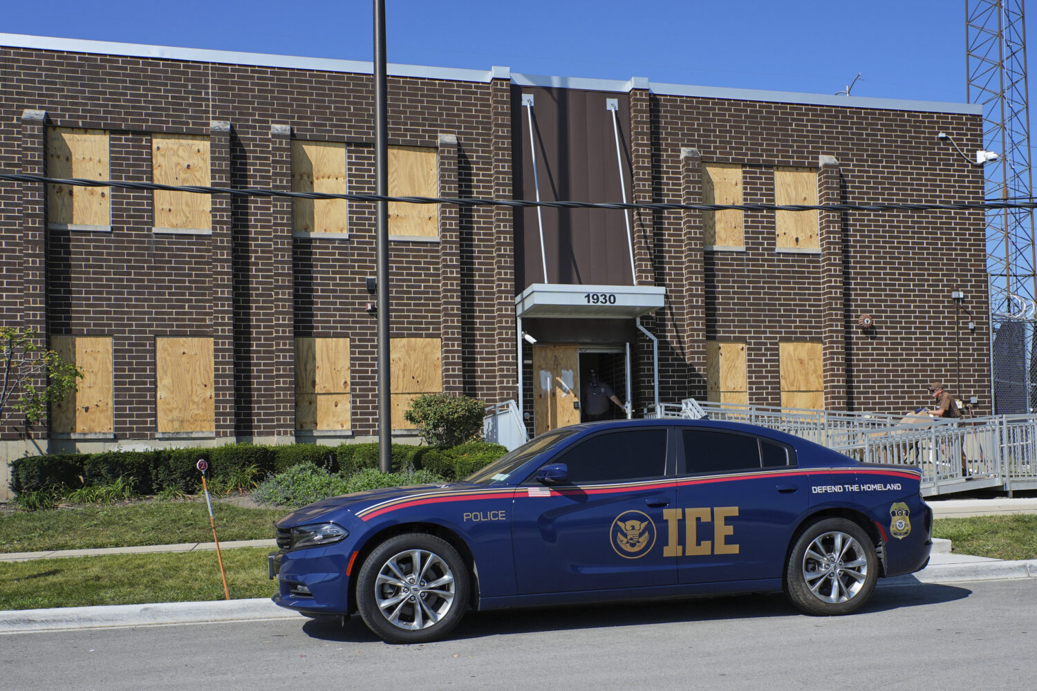 A U.S. Immigration and Customs Enforcement's (ICE) vehicle is parked in front of an ICE processing ...