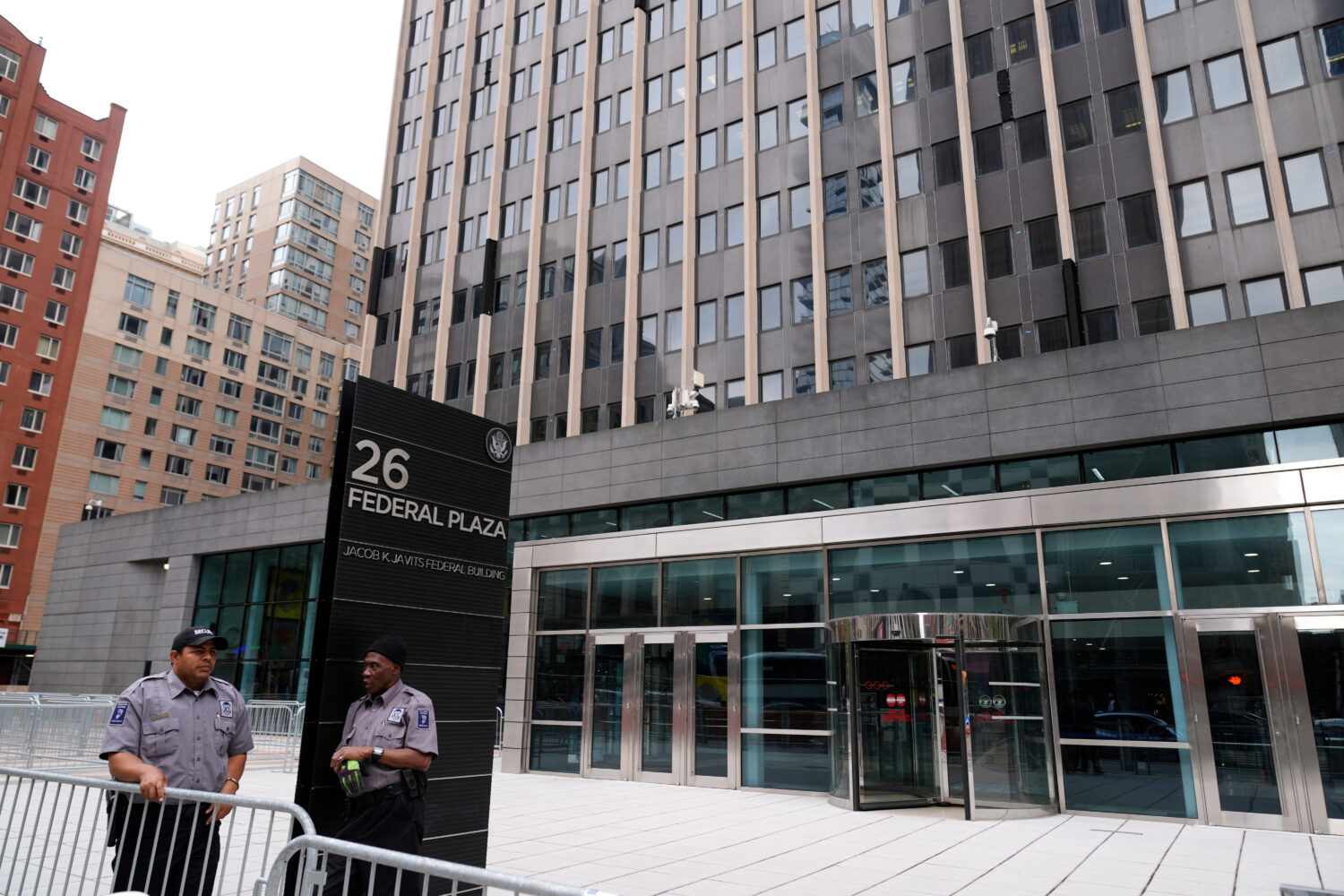 FILE - Security guards stand outside the Jacob K. Javits Federal Office Building at 26 Federal Plaz...