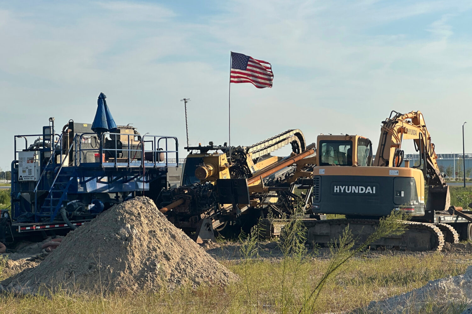 An American flag flies above a piece of heavy machinery at the site of Hyundai Motor Group's electr...