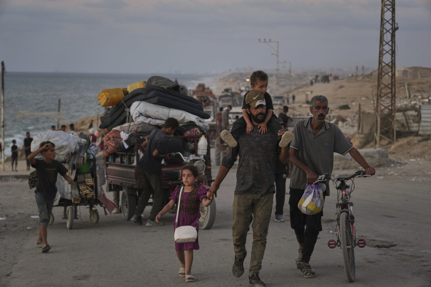 Displaced Palestinians flee northern Gaza along the coastal road toward the south, as Israel announ...