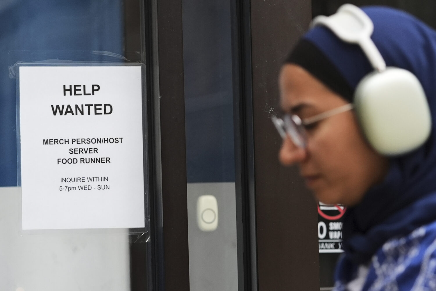 FILE - Help wanted sign is displayed at a live music and blues club in Chicago, Thursday, July 24, ...