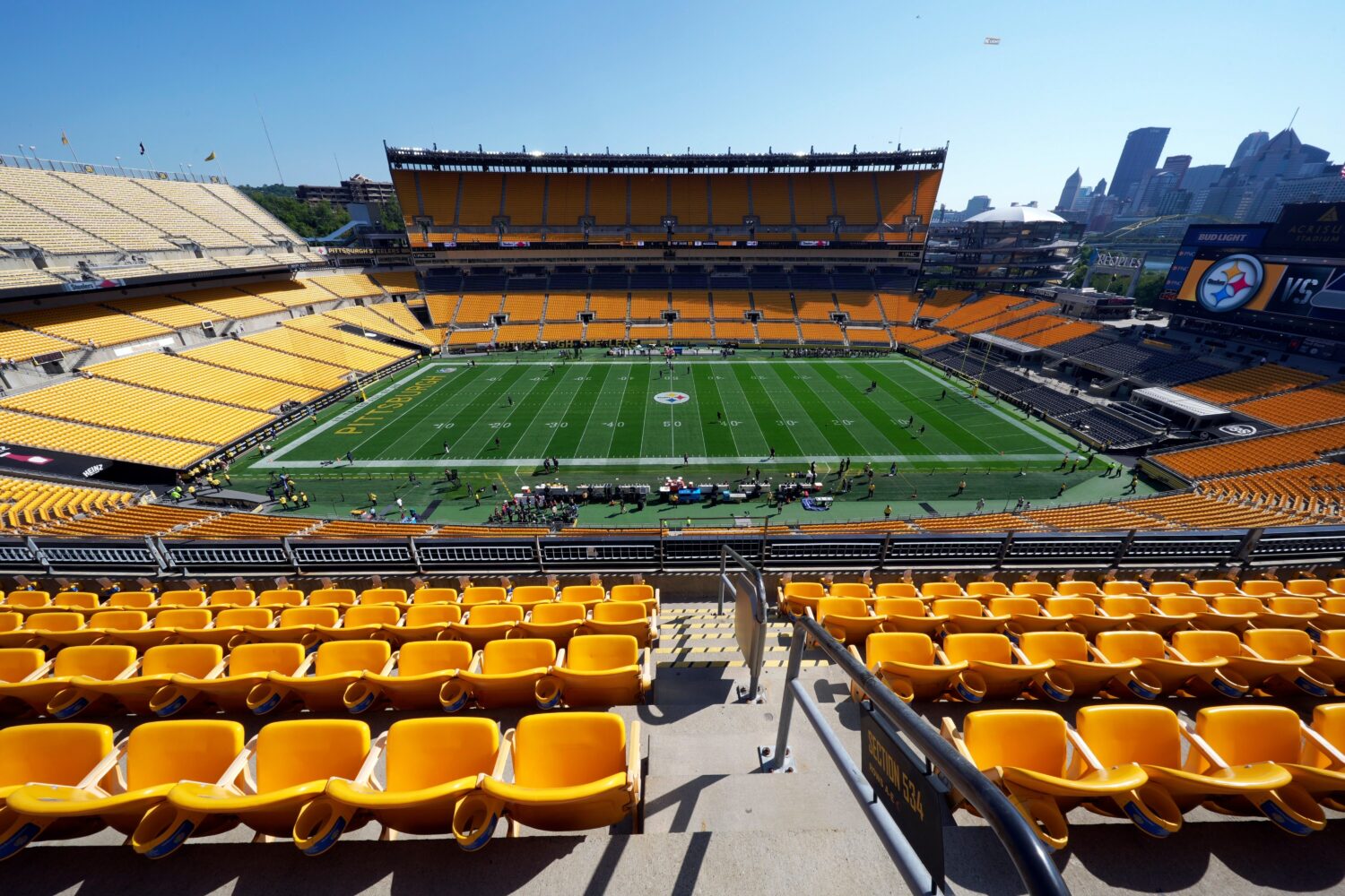 FILE - People stand on the field in Acrisure Stadium before an NFL football game between the Pittsb...