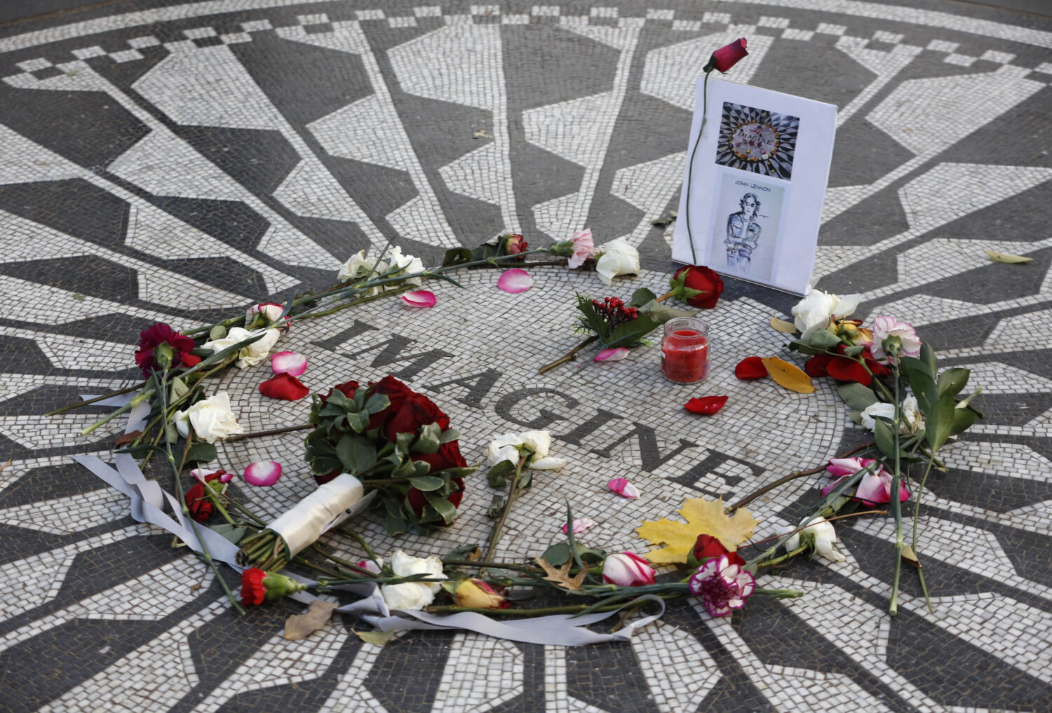 FILE - Flowers and a homemade tribute left by fans of the legendary musician adorn a memorial to Jo...