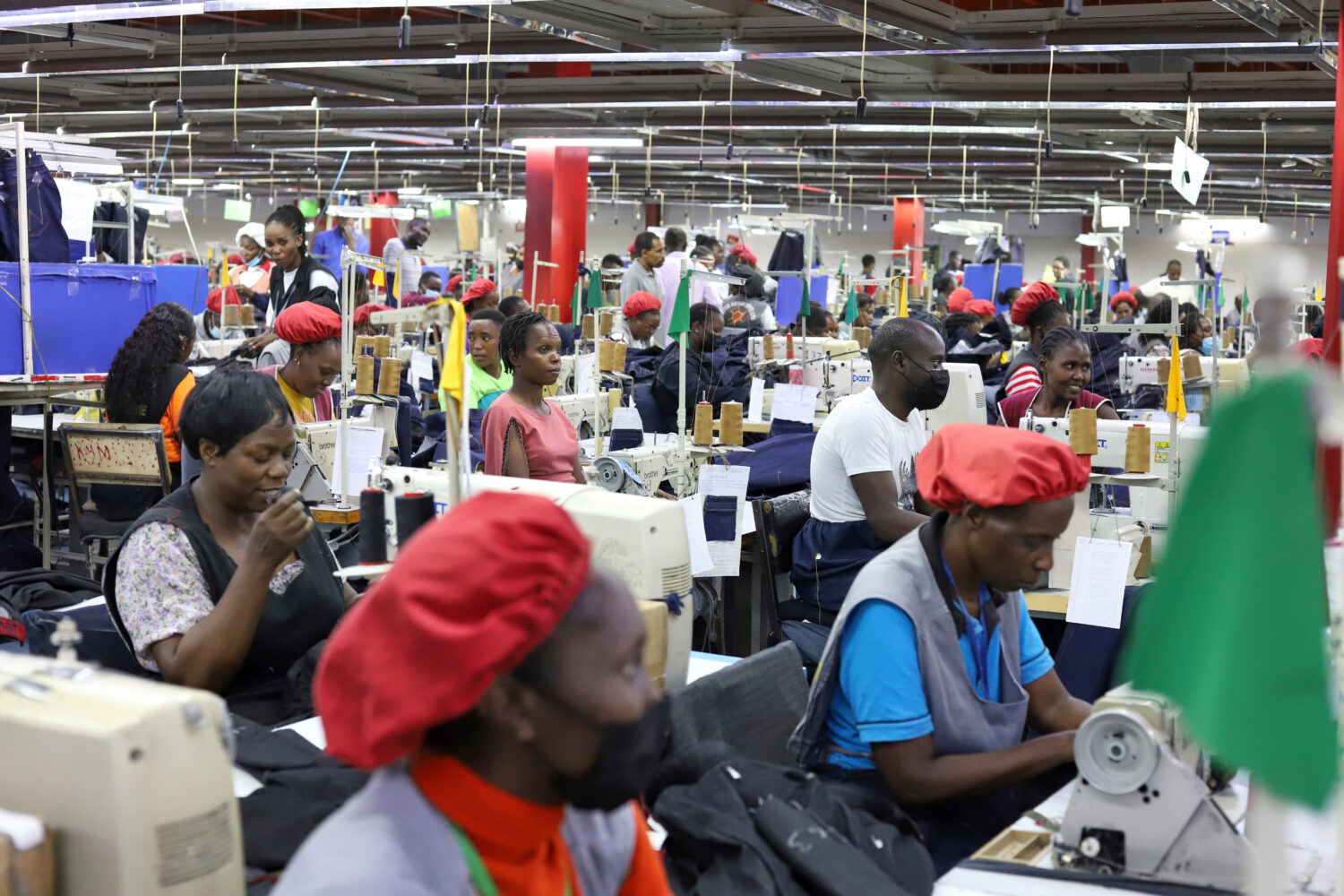 FILE - Factory workers operate machines to make garments at United Aryan EPZ Limited in Ruaraka on ...