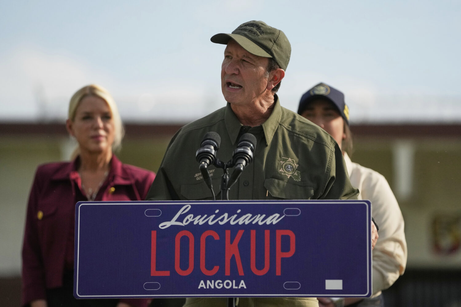 FILE - Louisiana Gov. Jeff Landry speaks to reporters outside "Camp 57," a facility to house immigr...