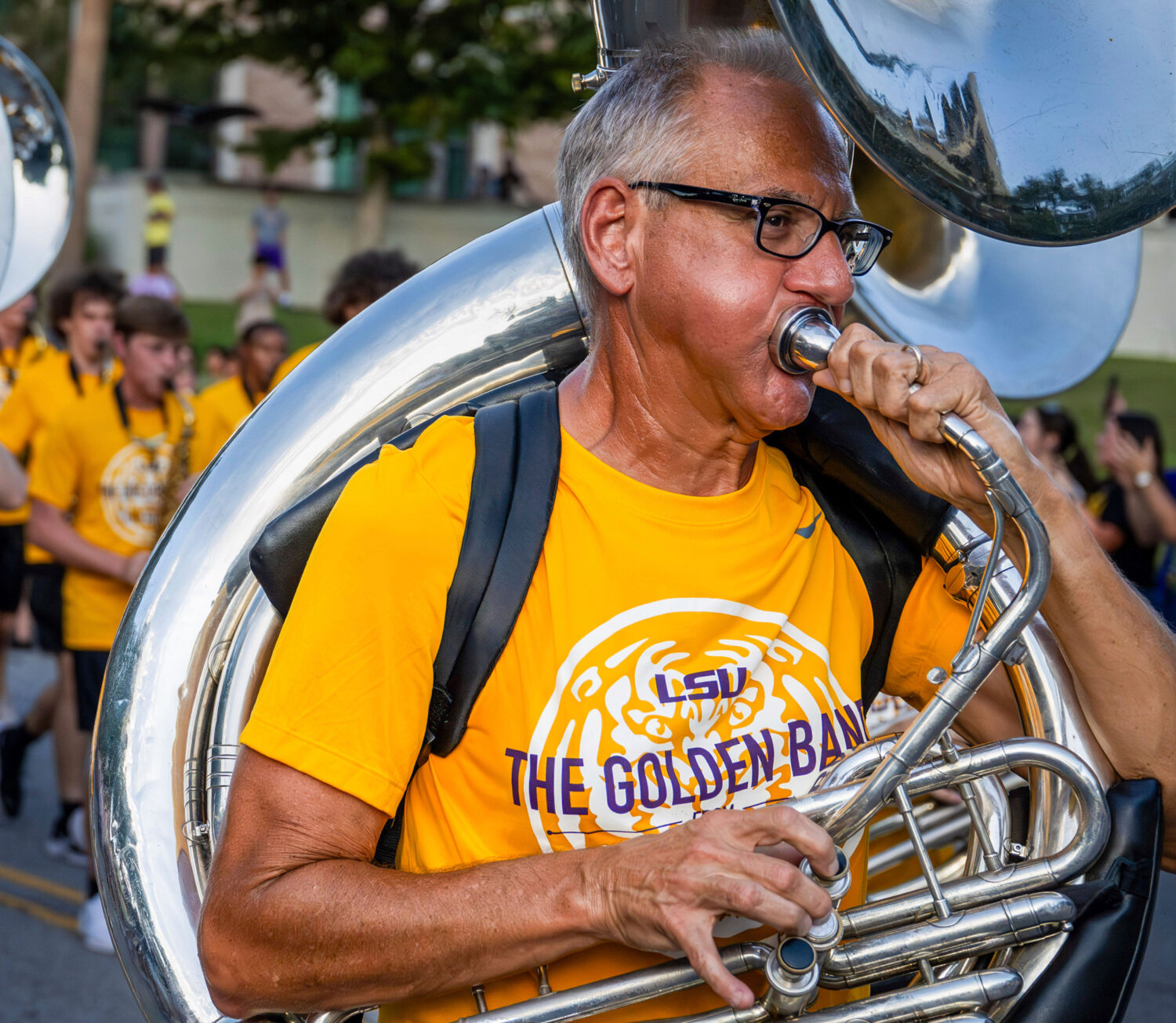 Kent Broussard performs with The Golden Band from Tigerland as they head down Victory Hill for a fi...