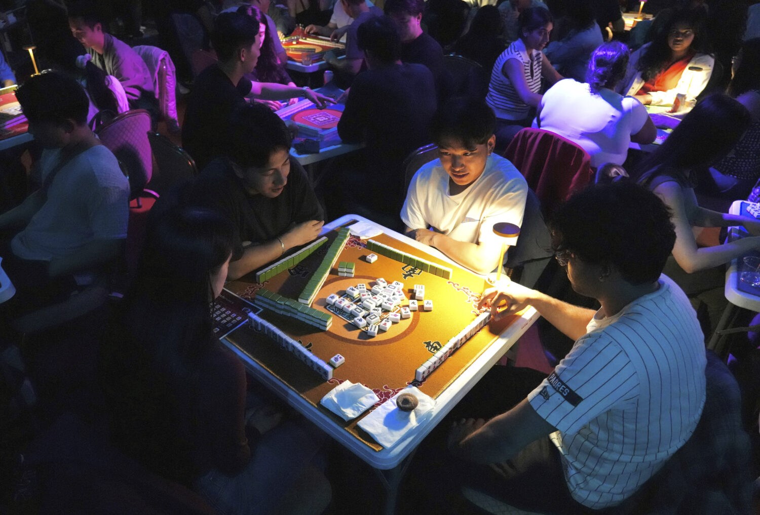 People play mahjong at an event organized by the YLL Mahjong Club on Friday, Aug. 15, 2025, in San ...