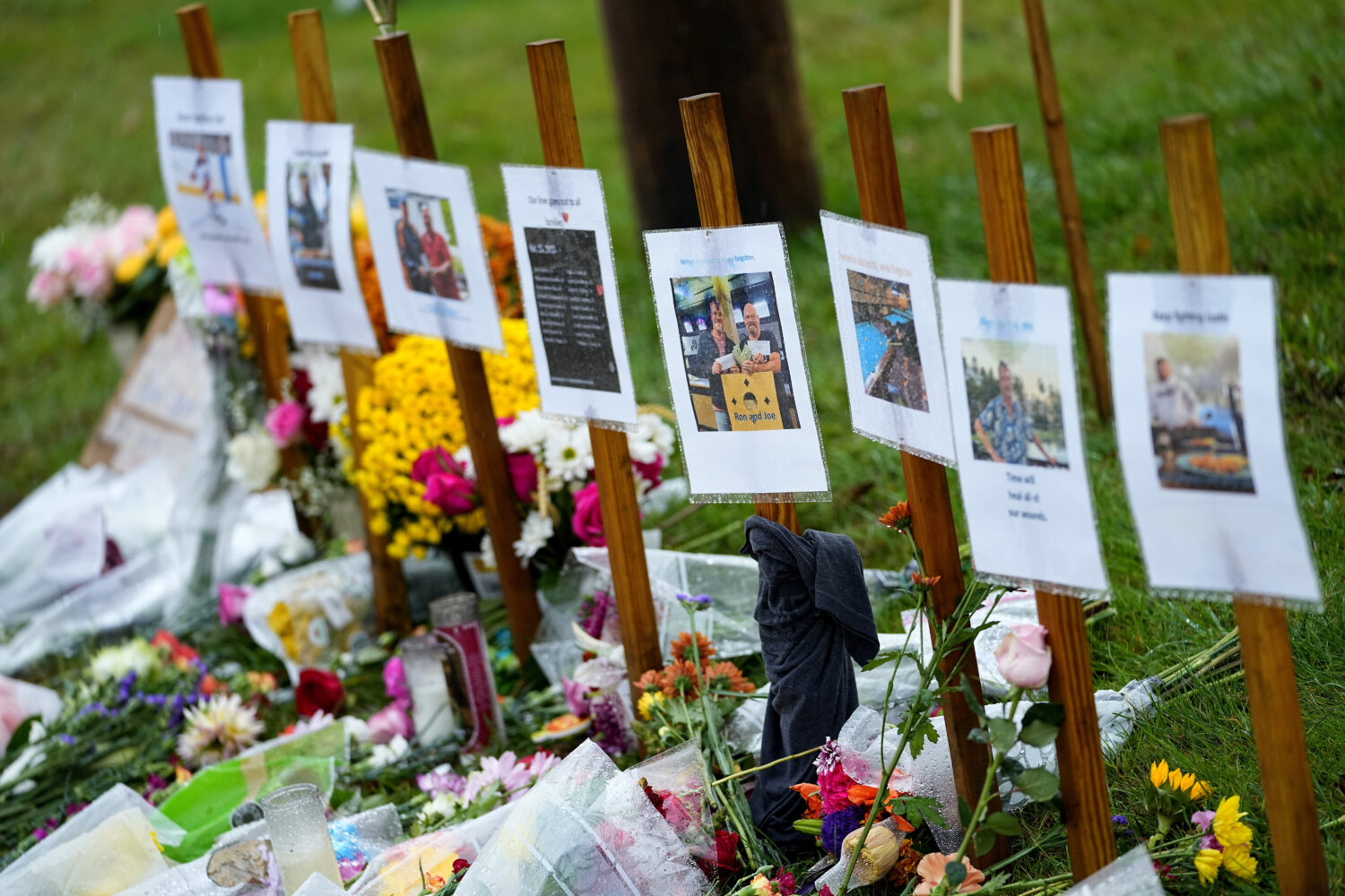 FILE — Rain soaked memorials for those who died in a mass shooting sit along the roadside by Sche...