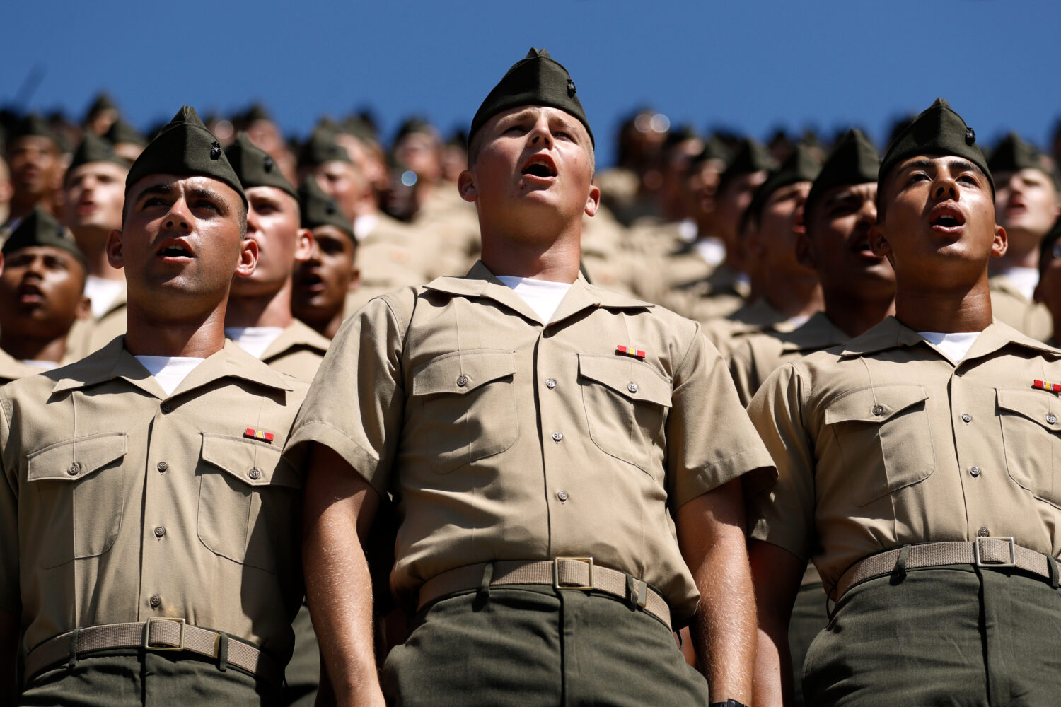FILE - Recruits from Marine Corps Recruit Depot San Diego sing the Marine's Hymn during a baseball ...