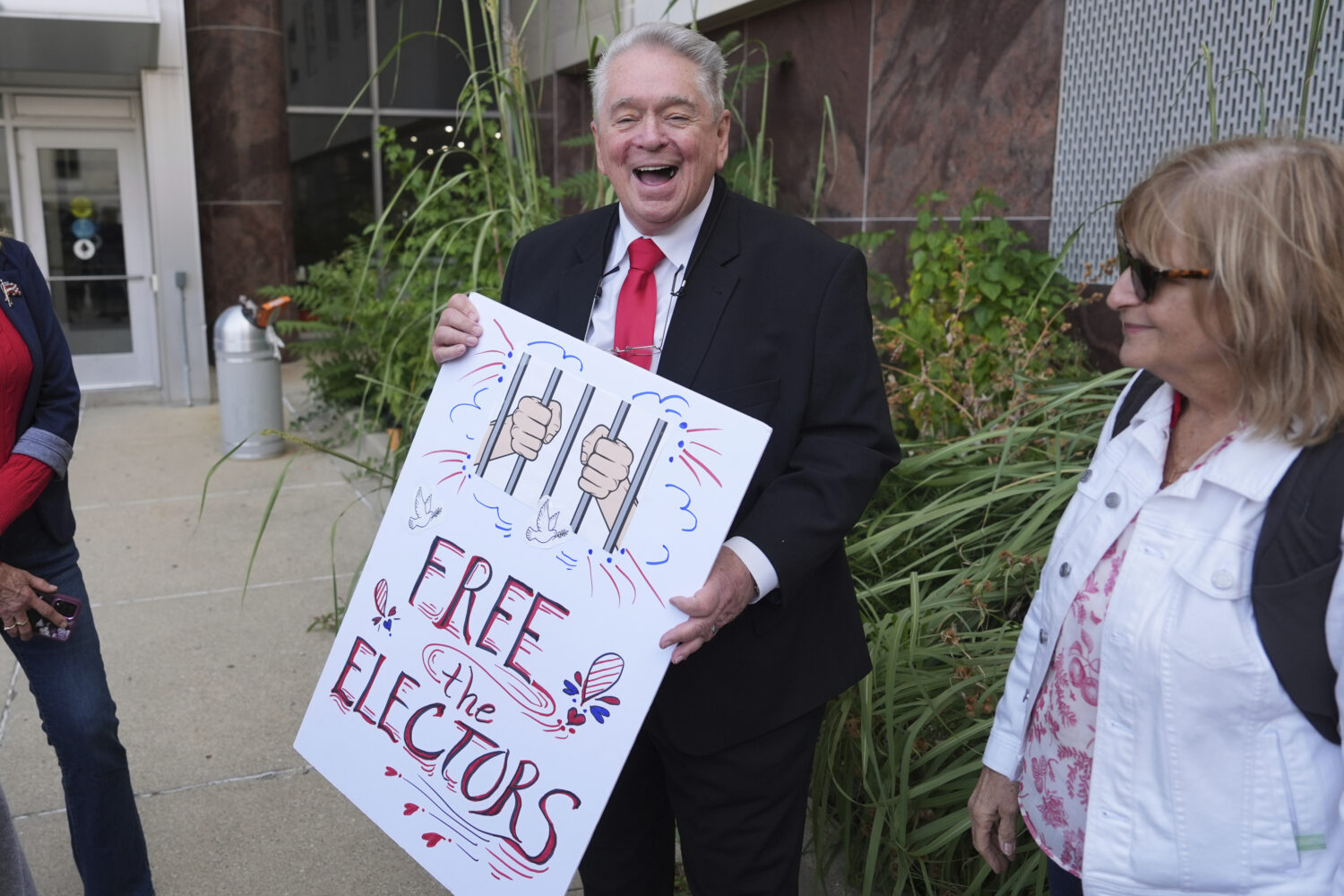 Clifford Frost holds a sign after a Michigan judge dismissed the criminal cases against 15 people a...