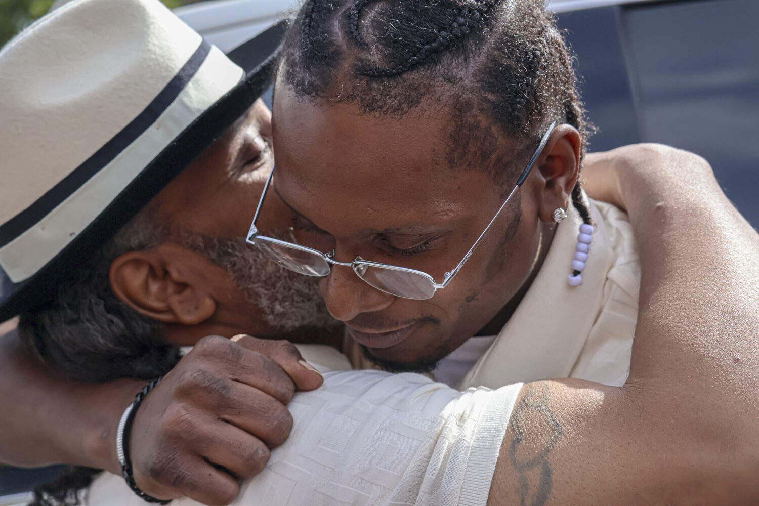After a judge found him innocent of a 1998 murder, Bryan Hooper Sr., left, embraces his son Bryan H...