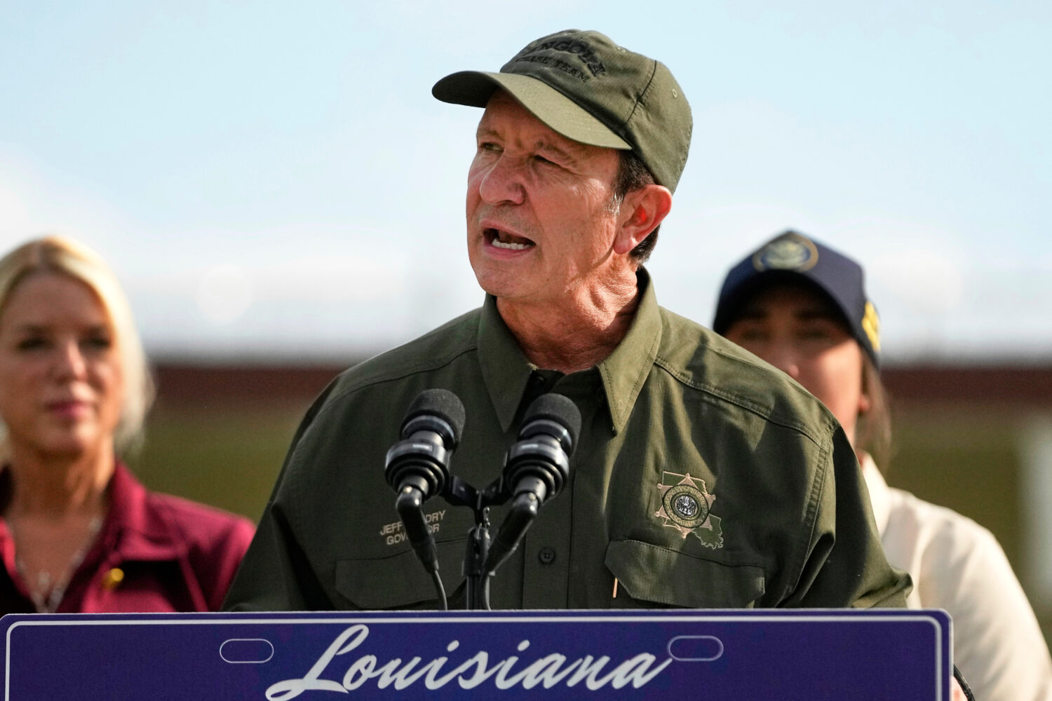FILE - Louisiana Gov. Jeff Landry speaks to reporters outside "Camp 57," a facility to house immigr...