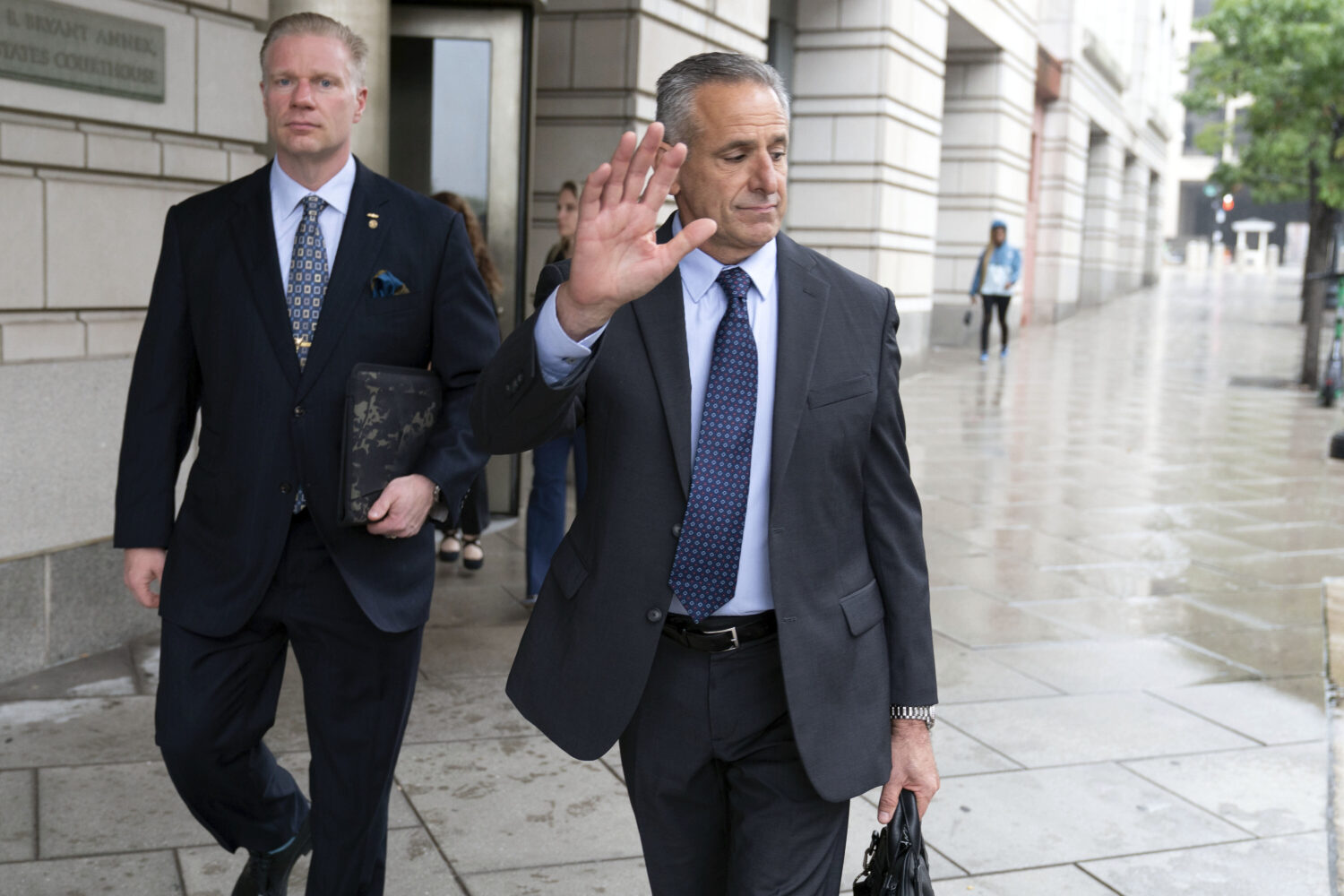 Retired Adm. Robert P. Burke, 63, right, walks out of the federal courthouse after being sentenced ...