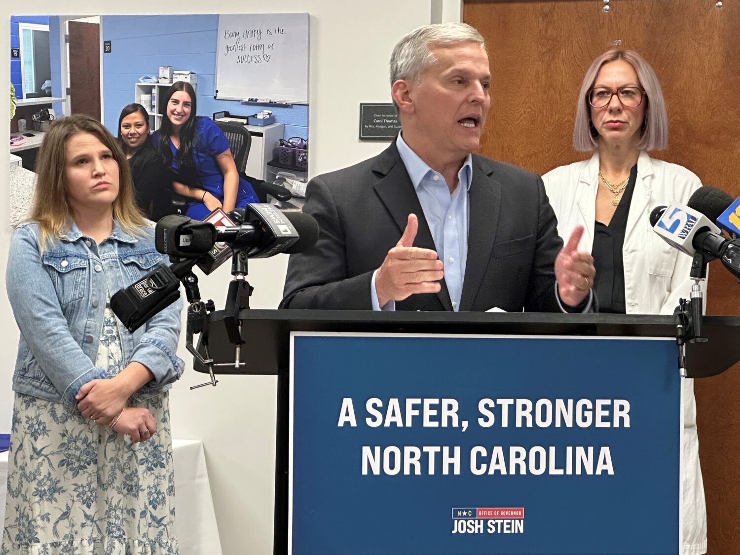 North Carolina Gov. Josh Stein speaks while Chelsea Gray of Rutherfordton, N.C., left, and Dr. Jenn...