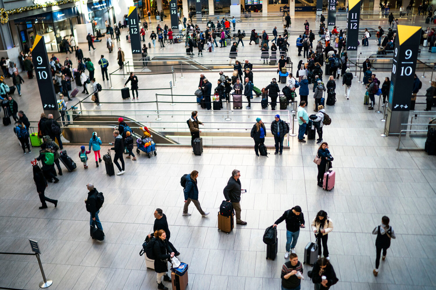 FILE - Travelers look for their gates to catch their trains departing at Penn Station in New York, ...