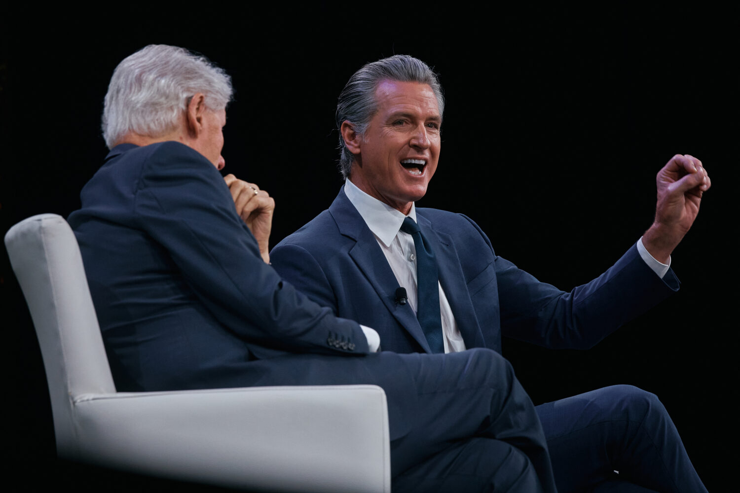 Governor of California Gavin Newsom, right, speaks next to former U.S. President Bill Clinton, left...