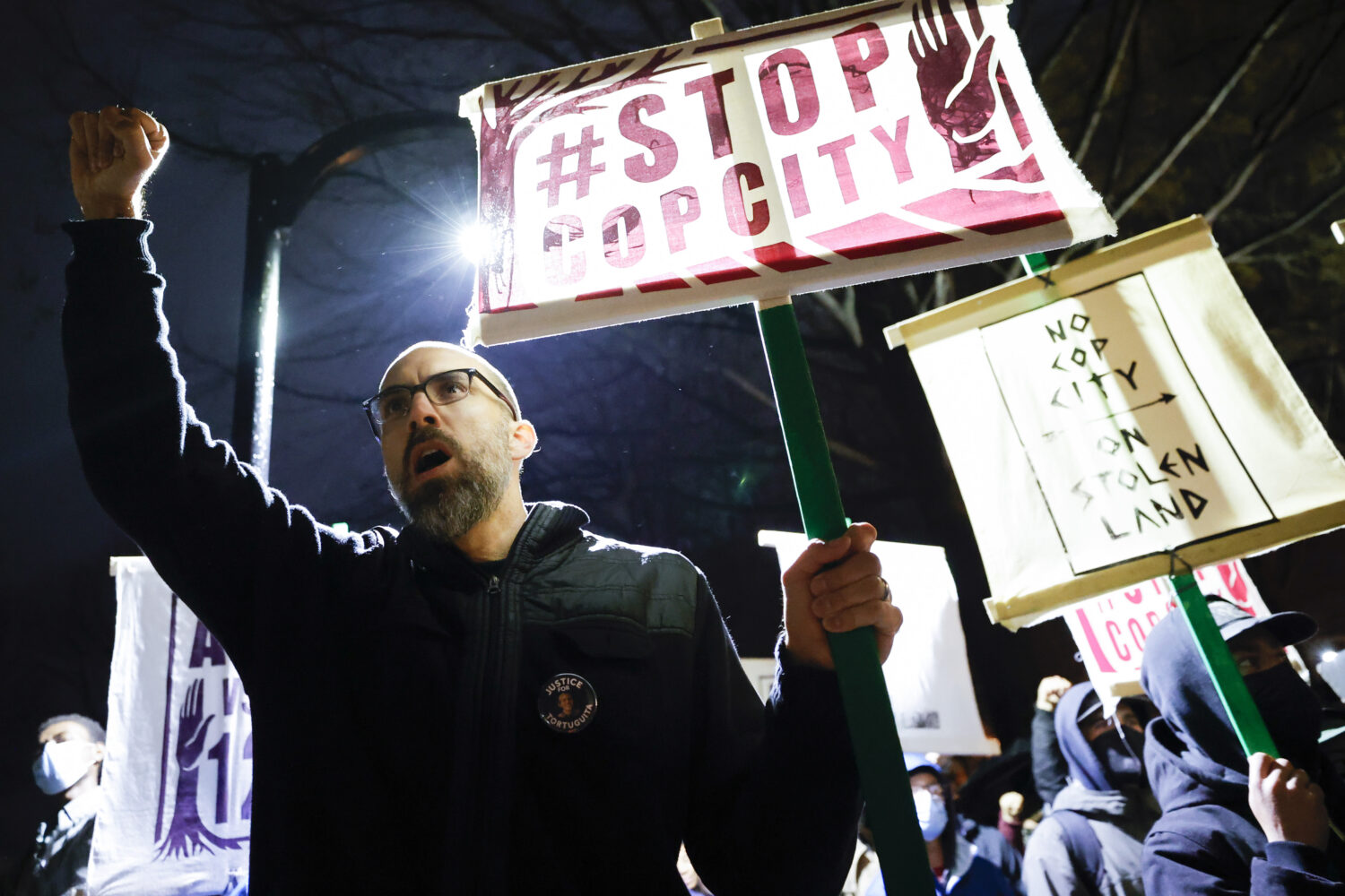 FILE - Andrew Douglas, of Atlanta, raises his fist during a protest over plans to build a police tr...