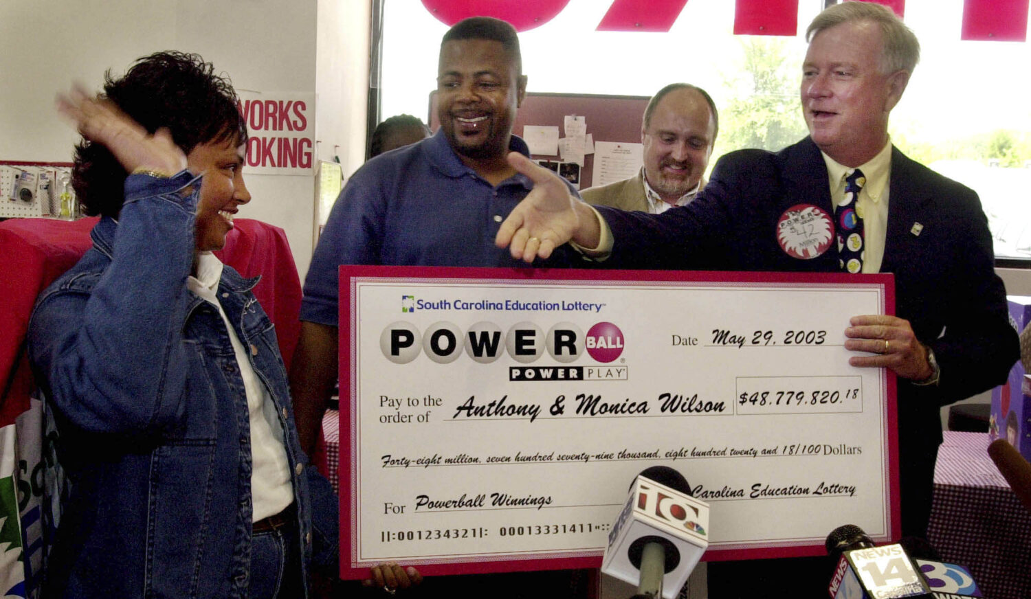 FILE - South Carolina Education Lottery Director, Ernie Passailaigue , right, extends his hand to M...