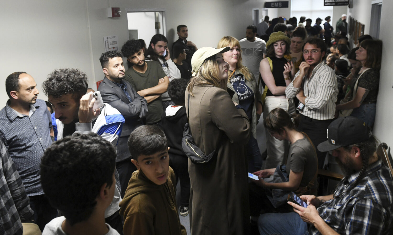 FILE - People who could not get into the Hamtramck city council chambers try to listen via YouTube ...
