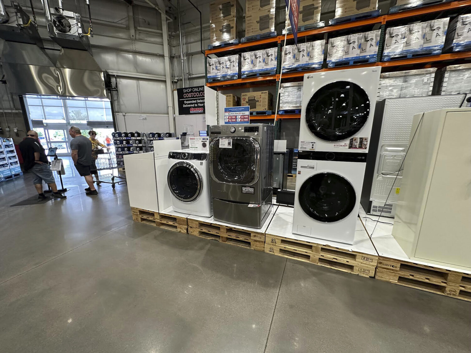 FILE - Washers stand on display near the entrance to a Costco warehouse Tuesday, July 8, 2025, in S...