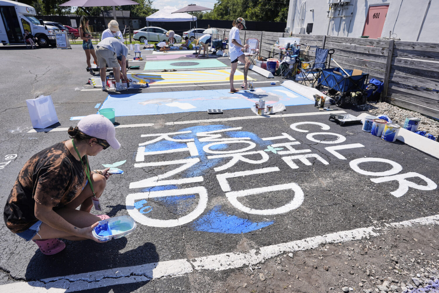 Tyler Blum paints a parking space at a local restaurant to support the LBGTQ+ community and to prot...