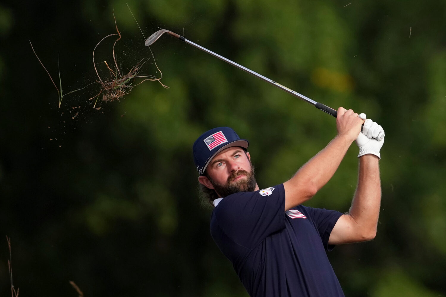 United States' Cameron Young hits from the rough on the 11th hole at Bethpage Black golf course dur...