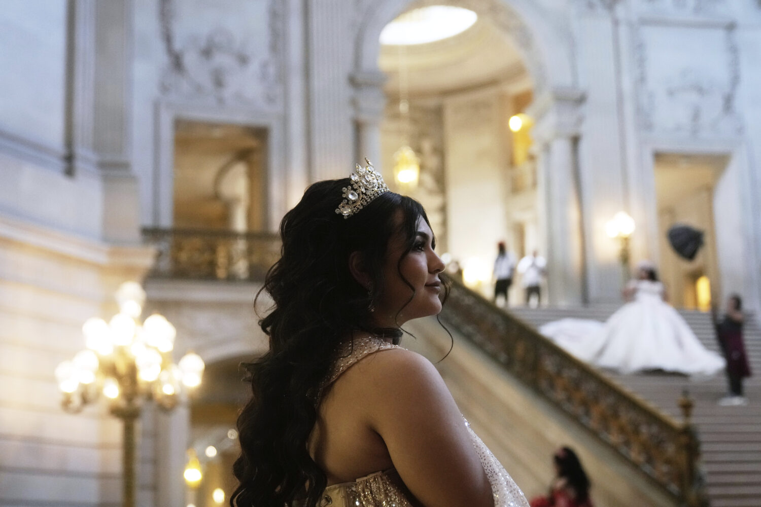 Allison Garcia stands in the City Hall rotunda for her quinceañera portrait session in San Francis...